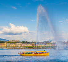 Bateau jaune traversant le lac de Genève devant le Jet d’eau