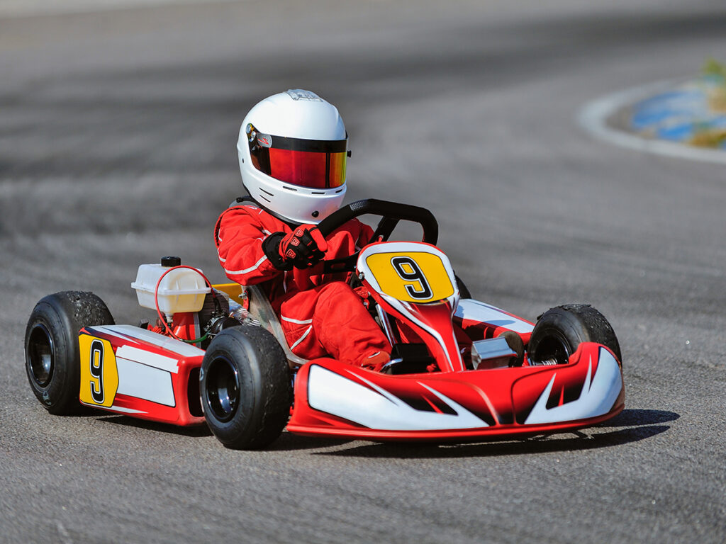 Niño conduciendo un kart en una pista